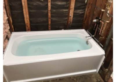 bathroom down to studs with new plumbing & a bathtub full of water (test)