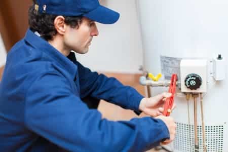 plumber working on water heater