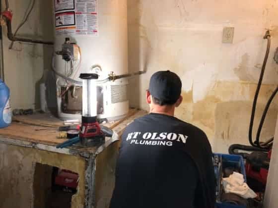 plumber working on water heater repair