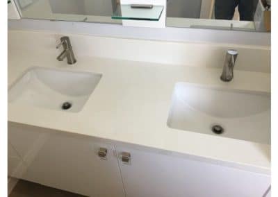 New dual white bathroom sinks installed