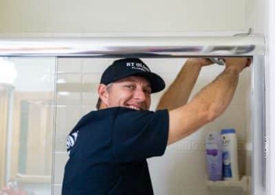 shower head installation by smiling RT Olson plumber