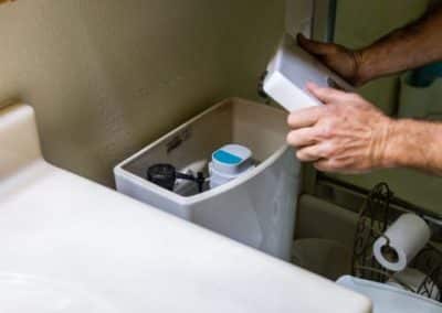 toilet repair being done by RT Olson Plumbing