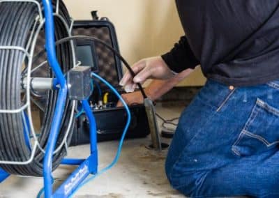 video inspection equipment being fed into drain by RT Olson Plumber