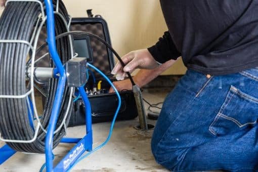 video inspection equipment being fed into drain by RT Olson Plumber
